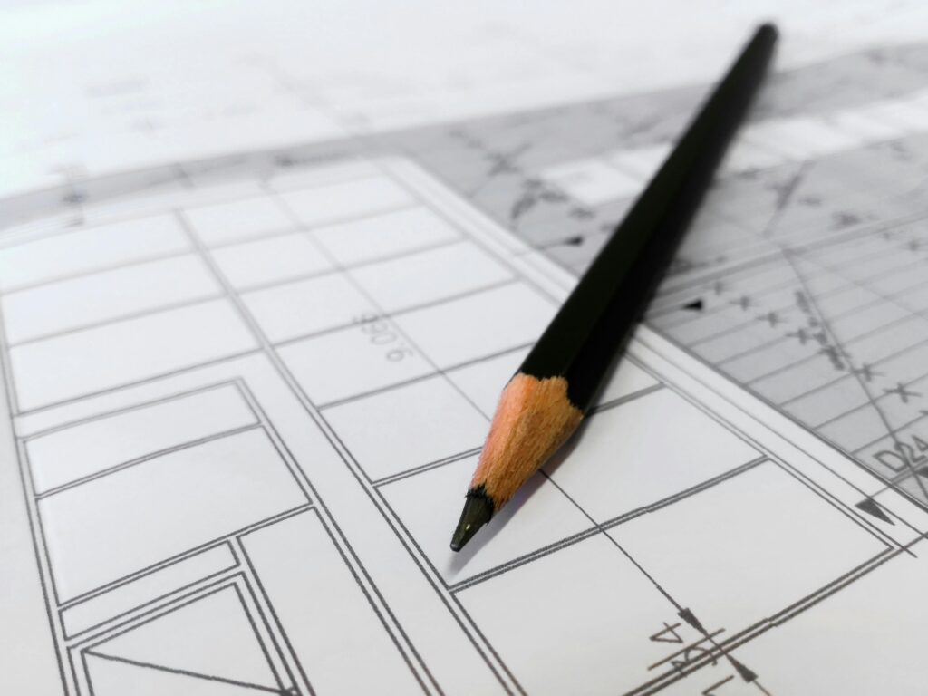 pexels photo 268362 268362 Detailed image of a black pencil resting on architectural blueprints, ideal for design and planning themes.